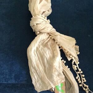 Selena Gomez lightweight tan scarf with Pom Pom detailing
